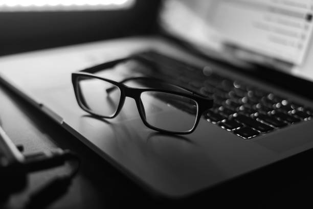 istock Glasses and a laptop on the table 859852486