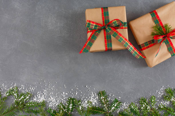 istock Handmade xmas gift boxes, top view, copy space on grey table background. Fir, decorated snow 859853234