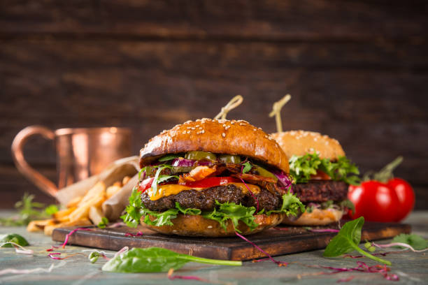 istock Tasty burgers on wooden table 859865342
