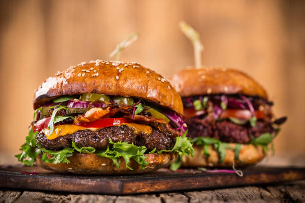 istock Tasty burgers on wooden table 859870340