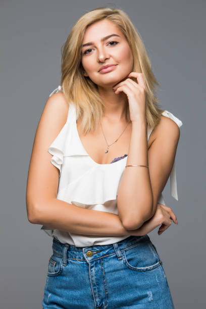 istock Smiling female model fashion posing isolated on grey background 859870366