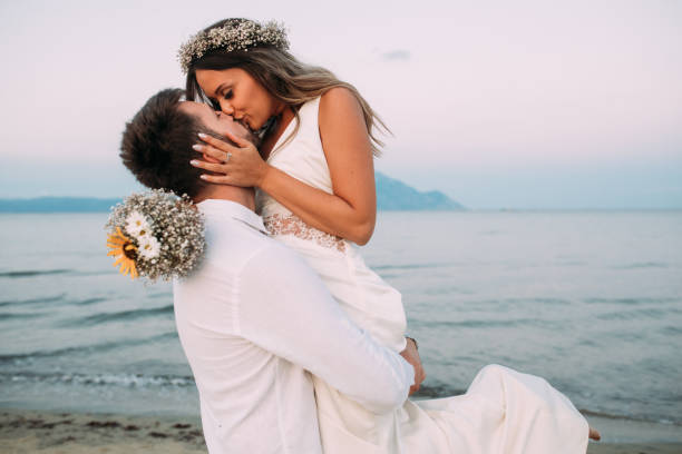 My love Photo of  young couple on beach bride photos stock pictures, royalty-free photos & images