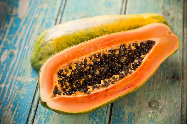 Fresh papaya on wooden background, close-up.