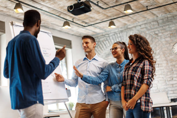 istock Business people with board having discussion 859890244