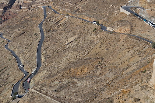 Road with many curves on the mountainous slope of Santorini. Greece