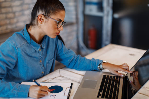 istock Young businesswoman taking notes from a laptop 859897286