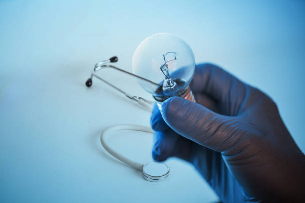 istock doctor hand hold a electric lamp with blue back ground 859900582
