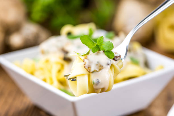 Porcini pasta as high detailed close-up shot on a vintage wooden table; selective focus