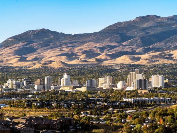 City of Reno Nevada cityscape in early autumn with hotels, casinos, apartments and mountains in the background. stock photo
