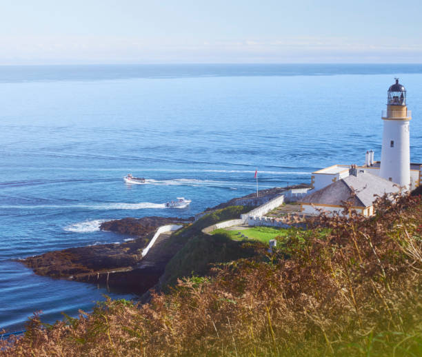 istock Lighthouse and fishing boats 859908702