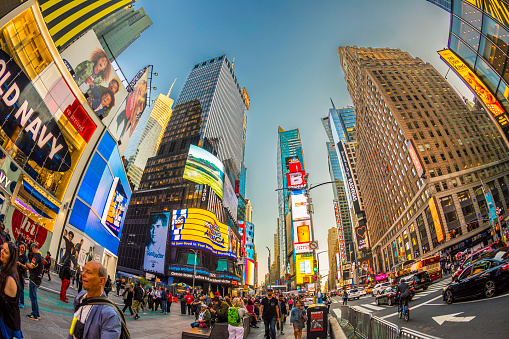 New York: neon advertising of News, brands and theaters at times square in late afternoon. Times square is a symbol for New York life and amusement.