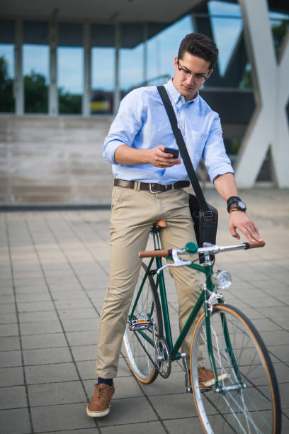 istock Businessman on his bike, using phone 859916814