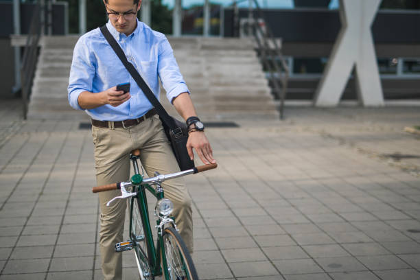 istock Businessman on his bike, using phone 859916862