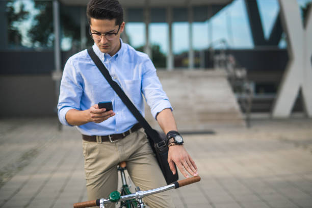 istock Businessman on his bike, using phone 859916886