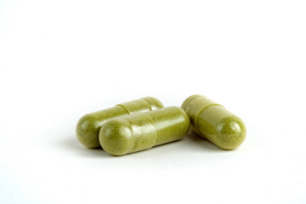 Moringa capsules on white background stock photo