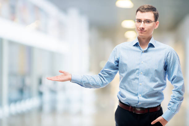 istock Businessman presenting space to the left in office 859918350