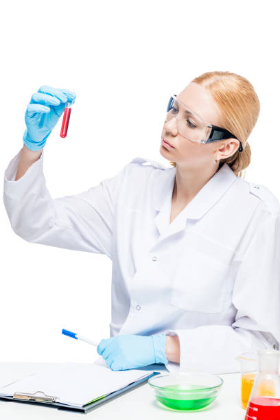 istock Beautiful female lab assistant with test tubes posing on white background 859918386