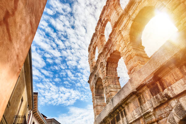 Arena of Verona, ancient roman amphitheater in Italy during sunrise and blue sky with clouds. Arena of Verona, ancient roman amphitheater in Italy during sunrise and blue sky with clouds verona opera stock pictures, royalty-free photos & images