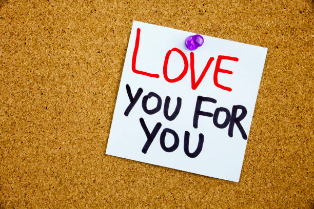 istock A yellow sticky note writing, caption, inscription Phrase LOVE YOU FOR YOU in black ext on a WHITE sticky note pinned to a cork notice board 859936994