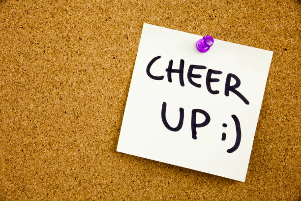 istock A yellow sticky note writing, caption, inscription Phrase CHEER UP in black ext on a sticky note pinned to a cork notice board 859940134