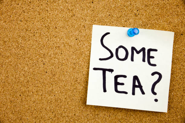 istock A yellow sticky note writing, caption, inscription Phrase SOME TEA in black ext on a sticky note pinned to a cork notice board 859944912