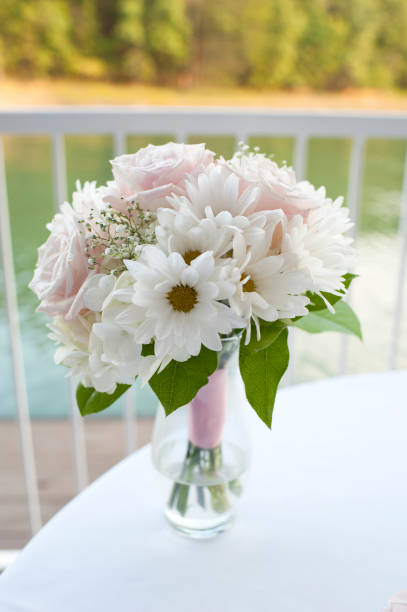 istock Flowers in vase by lake for wedding 859945184