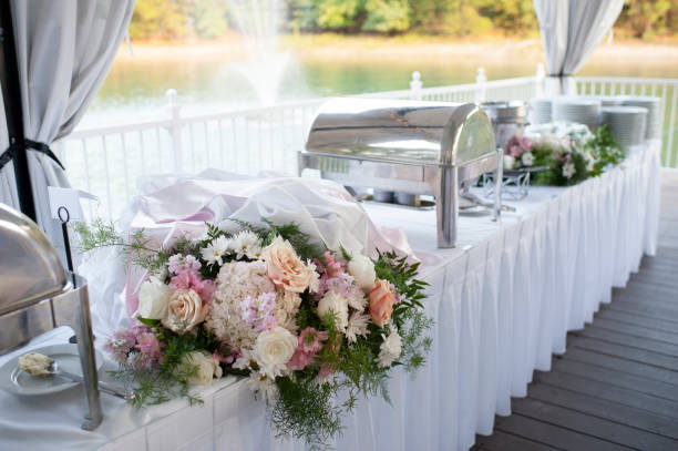 Food table set up by lake for wedding