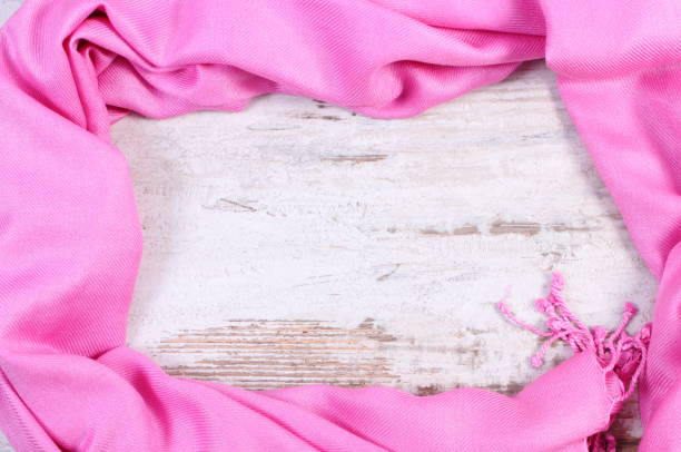 istock Frame of pink shawl, copy space for text on old rustic board 859947530