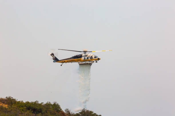 Helicopter doing drops of water on the La Tuna wildfire in Los Angeles Helicopter flying around doing water and fire retardant drops on the moutains of Los Angeles. 

 military tanker airplane photos stock pictures, royalty-free photos & images