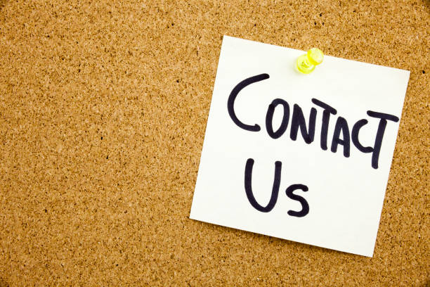 istock A yellow sticky note writing, caption, inscription Phrase CONTACT US in black ext on a sticky note pinned to a cork notice board 859966622