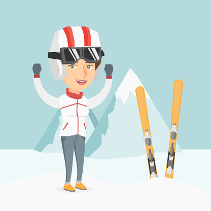 Young caucasian skier standing with raised hands