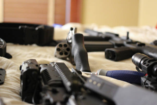 istock Bed Full of guns 859971820