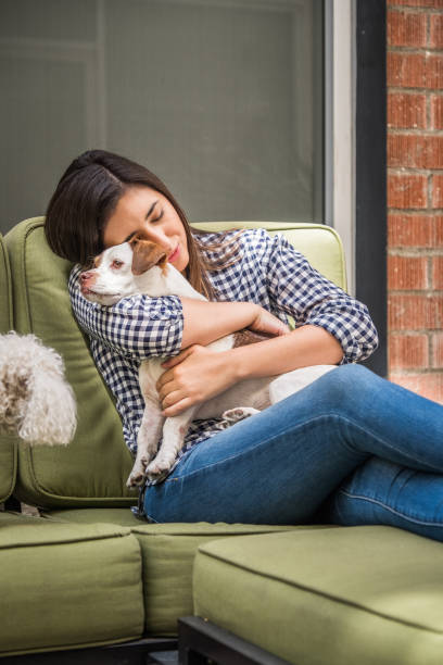 istock Living with Pets - Woman Hugging her Dog 859978934