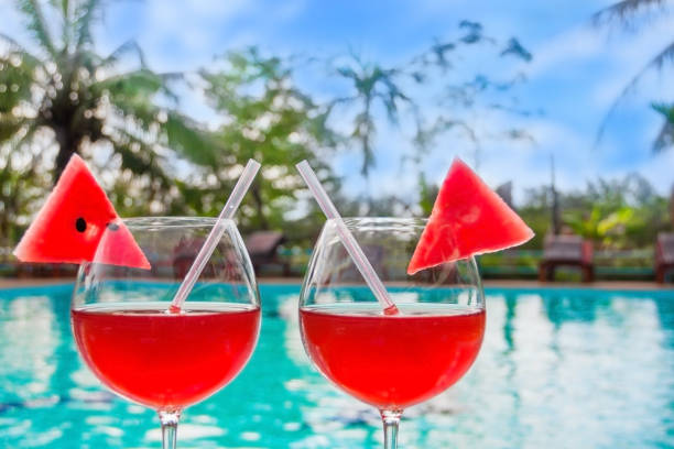 istock Two red cocktails near swimming pool 859980680