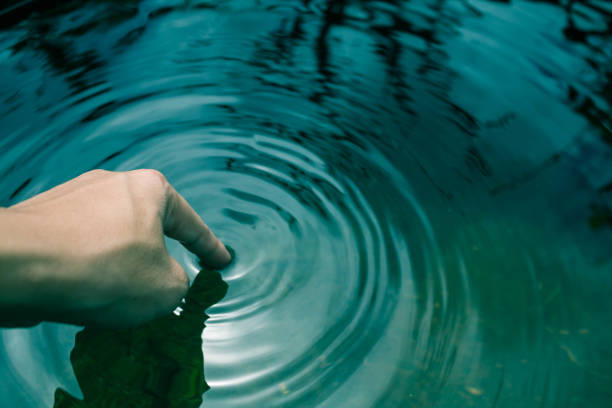 istock The hands dipped in blue water until the waves. 859983298