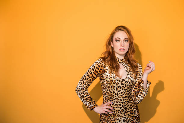 istock Monochrome - Leopard Woman on Orange Background 859983436