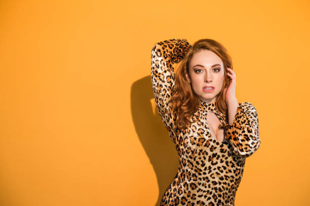 istock Monochrome - Leopard Woman on Orange Background 859983514