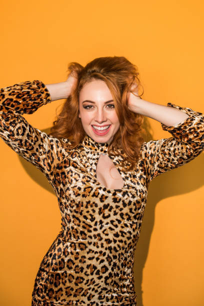 istock Monochrome - Leopard Woman on Orange Background 859983652
