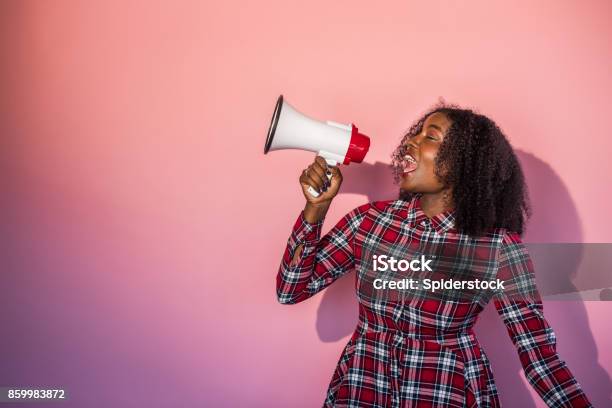 Monochrome Black Woman On Pink Background Yells Into Megaphone Stock Photo - Download Image Now
