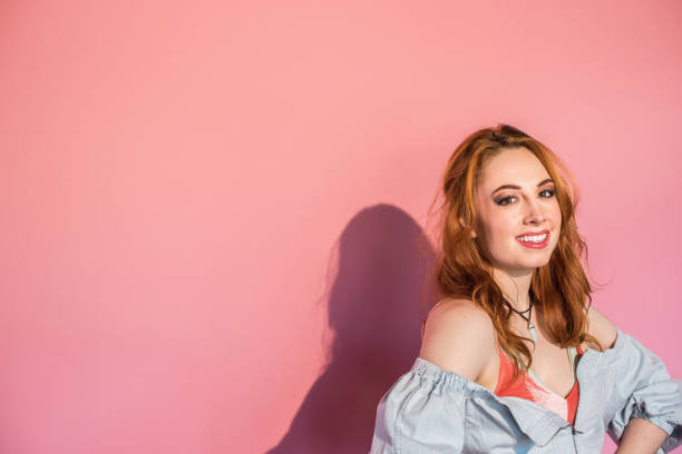 istock Monochrome - Confident Redhead Woman on Pink Background 859987126