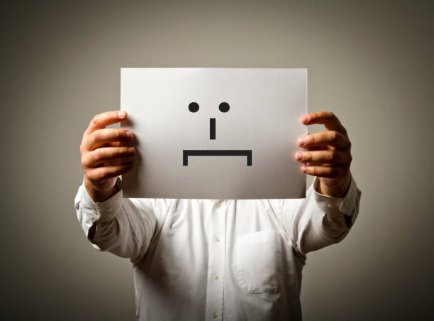 istock Man is holding white paper with smile. Embarrassed and confused concept. 859990978