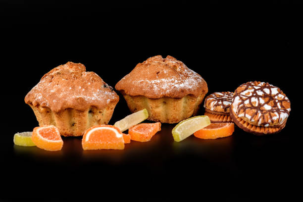 istock Chocolate biscuit cake, cookies and fruit candy close-up on a black background 859991100
