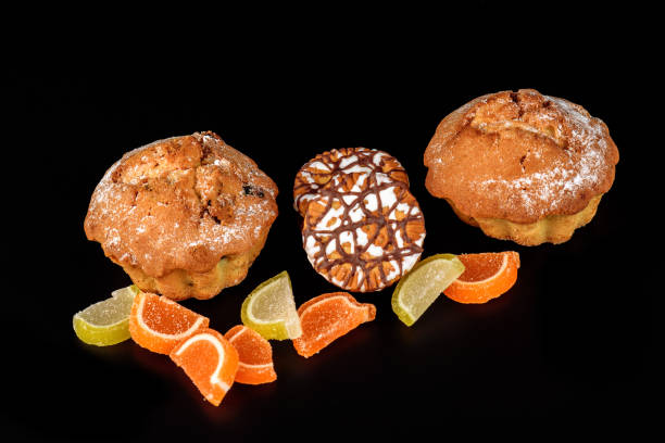istock Chocolate biscuit cake, cookies and fruit candy close-up on a black background 859991126