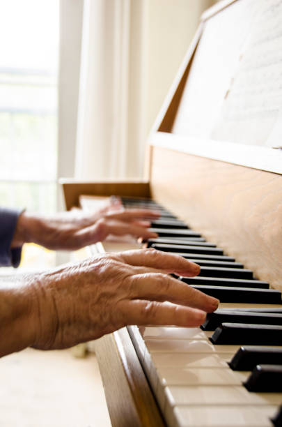 istock Old person play the piano with wrinkled hands 859995368