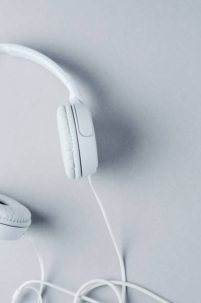 istock White headphones on a gray background 859996298