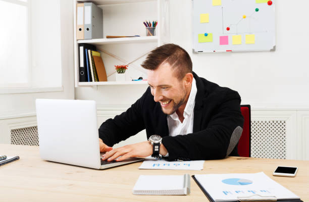 istock Young businessman with laptop in the office 860000184