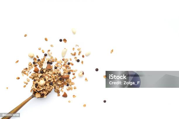 Crumbled Granola With A Wooden Spoon On A White Background Top View Stock Photo - Download Image Now