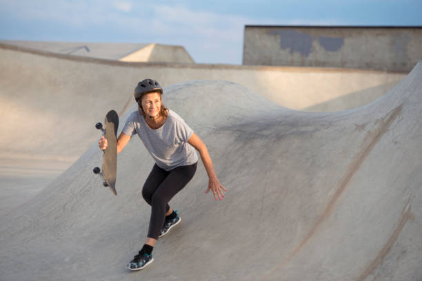 istock Senior woman skateboarding. 860004082