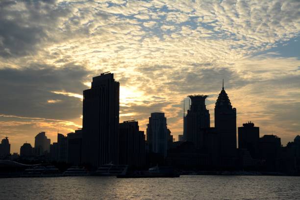 istock Huangpu river and Puxi skyline under dramatic sky at sunset, Shanghai, China 860004172