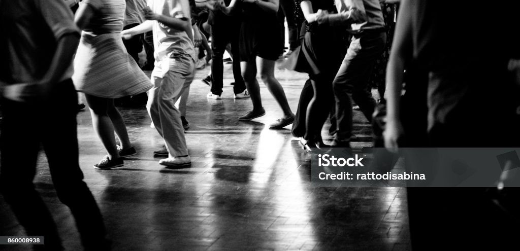 Bottom view of People legs dancing in black and white Low view of people dancing in the hall Retro Style Stock Photo